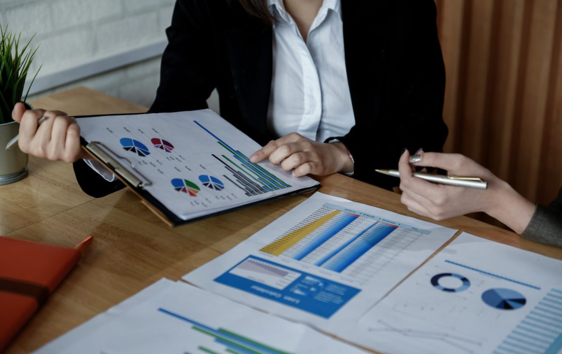 Team of female accountants are working on data documents.