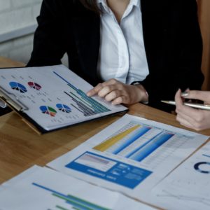 Team of female accountants are working on data documents.